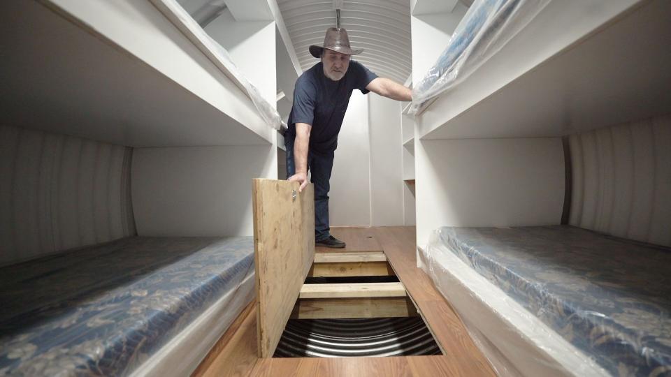 Hubbard showing off the storage space inside of the bunkers. (Photo: Yahoo Finance)