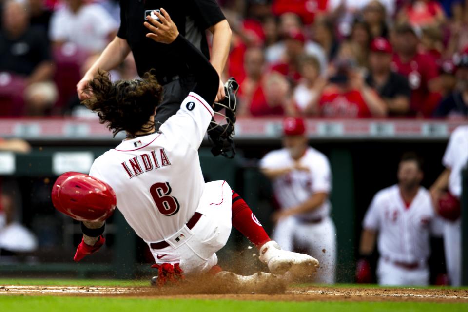 Cincinnati Reds second baseman Jonathan India (6) slides into home on a sacrifice fly ball in the first inning of the MLB baseball game between Cincinnati Reds and Atlanta Braves at Great American Ball Park in Cincinnati on Thursday, June 24, 2021.