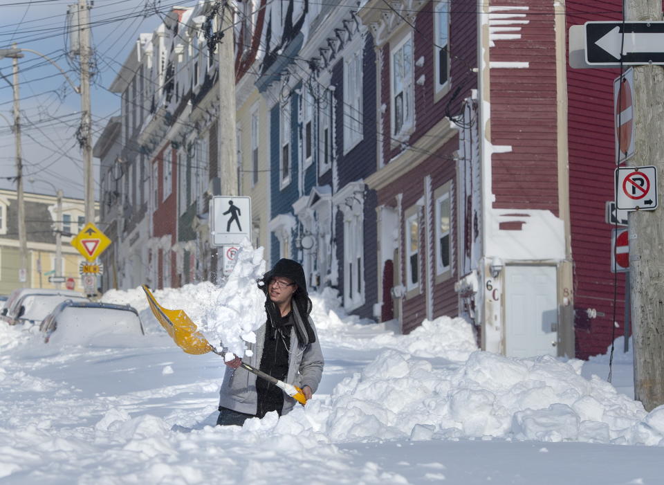 A resident digs a path from his house in St. John's Newfoundland on Saturday, Jan. 18, 2020. The state of emergency ordered by the City of St. John's is still in place, leaving businesses closed and vehicles off the roads in the aftermath of the major winter storm that hit the Newfoundland and Labrador capital. (Andrew Vaughan/The Canadian Press via AP)