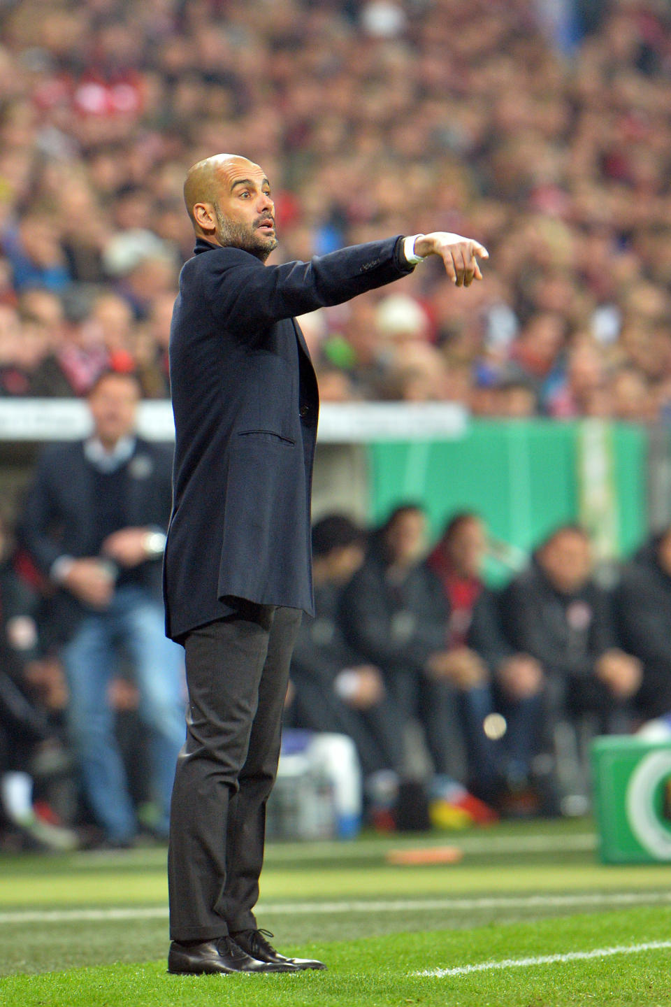 Munich head coach Pep Guardiola points during the German soccer cup, DFB Pokal, semifinal match between FC Bayern Munich and FC Kaiserslautern in the Allianz Arena in Munich, Germany, on Wednesday, April 16. 2014. (AP Photo/Kerstin Joensson)