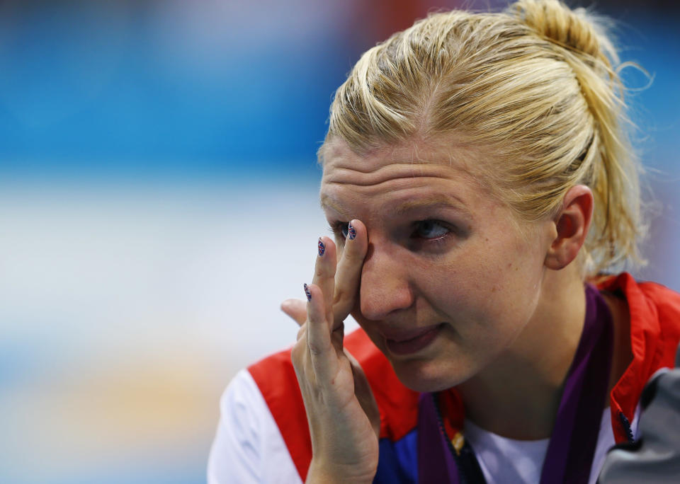 Britain's Rebecca Adlington wipes away tears after receiving her bronze medal during the women's 800m freestyle victory ceremony at the London 2012 Olympic Games at the Aquatics Centre