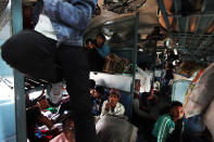 Passenagers settle inside an overcrowded train in New Delhi, India.