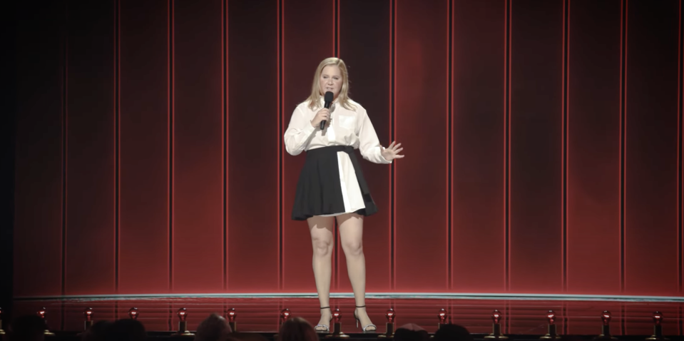 Amy Schumer performing onstage.