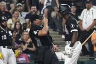 Home plate umpire Nick Mahrley reacts after Chicago White Sox's Tim Anderson made contact with Mahrley during the seventh inning of the team's baseball game against the Oakland Athletics on Friday, July 29, 2022, in Chicago. (AP Photo/Charles Rex Arbogast)