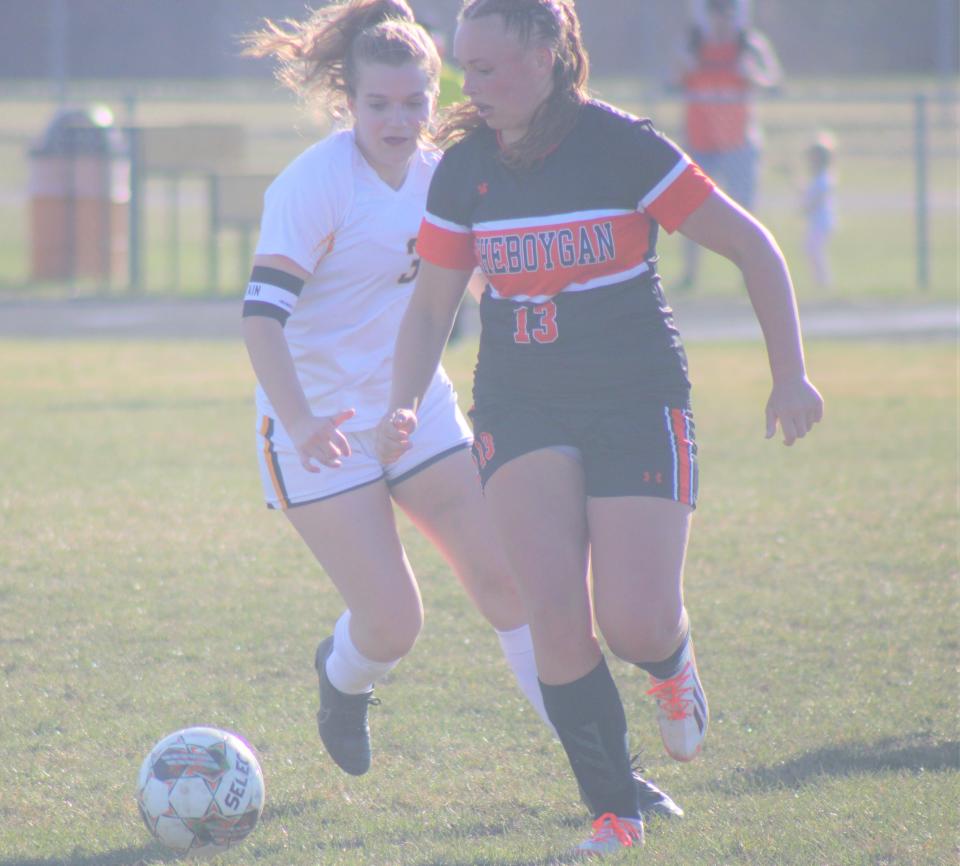 Cheboygan freshman midfielder Elise Markham (13) keeps control of the ball during the second half of Monday's girls soccer home clash against Roscommon.