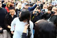 <p>A demonstrator cuts hair during a protest following the death of Mahsa Amini, in front of the Brandenburg Gate in Berlin, Germany, September 23, 2022. REUTERS/Christian Mang</p> 