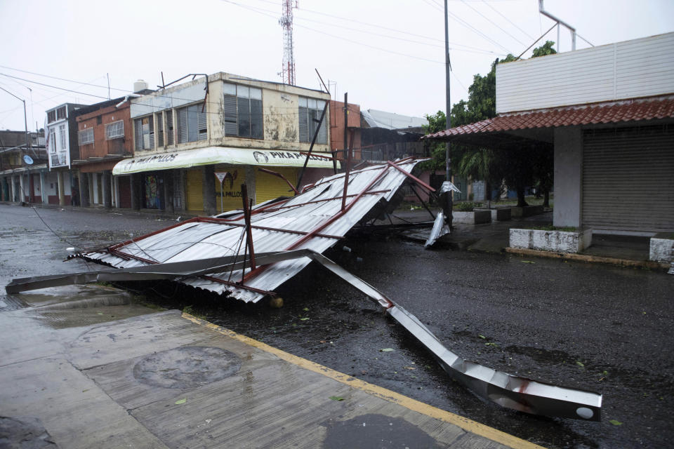 A fallen structure blocks a street after the passing of Hurricane Rick in Lazaro Cardenas, Mexico, Monday, Oct. 25, 2021. Hurricane Rick roared ashore along Mexico's southern Pacific coast early Monday with winds and heavy rain amid warnings of potential flash floods in the coastal mountains. (AP Photo/Armando Solis)