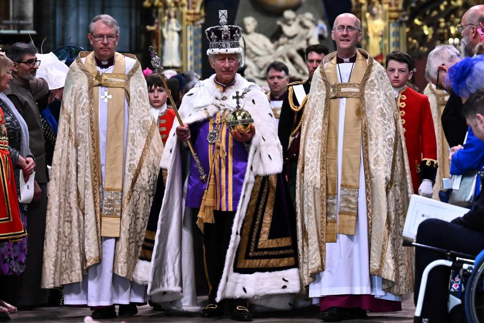 Britain's King Charles III wearing the Imperial state Crown and carrying the Sovereign's Orb and Sceptre leave Westminster Abbey after the coronation in central London Saturday, May 6, 2023. The set-piece coronation is the first in Britain in 70 years, and only the second in history to be televised. Charles will be the 40th reigning monarch to be crowned at the central London church since King William I in 1066.