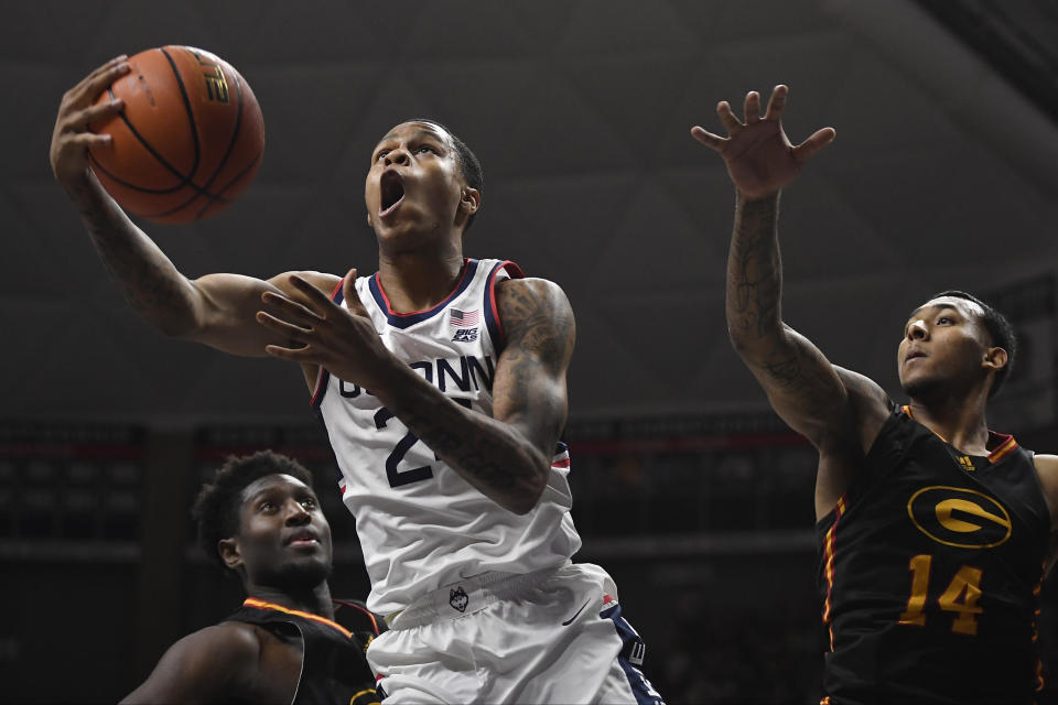 Connecticut's Jordan Hawkins goes up to the basket as Grambling State's A.J. Taylor (14) defends in the first half of an NCAA college basketball game, Saturday, Dec. 4, 2021, in Storrs, Conn. (AP Photo/Jessica Hill)