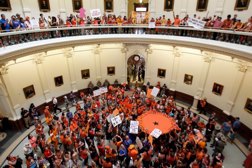 Abortion rights (in orange) and anti-abortion advocates (in blue) rally in the rotunda of the State Capitol, as the state Senate meets to consider legislation restricting abortion rights in Austin, Texas on July 12, 2013. Mike Stone, Reuters.