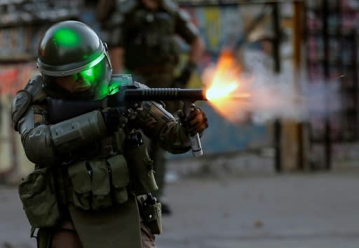 Chilean riot police faced off against anti-government demonstrators protesting in one of Santiago's wealthiest neighborhoods