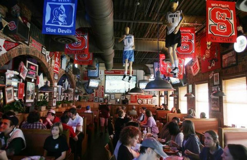 Fans take in college basketball at the Carolina Ale House in Durham. The sports bar chain plans to open a restaurant in the new White Oak development in March.