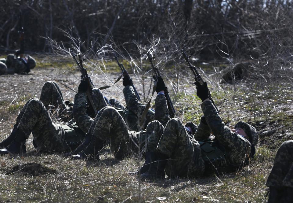 Ukrainian border guards perform an exercise in anti-air attack during training at a military camp in the village of Alekseyevka on the Ukrainian-Russian border, eastern Ukraine, Friday, March 21, 2014. Russian President Vladimir Putin has signed a resolution approved by parliament to annex Crimea. (AP Photo/Sergei Grits)