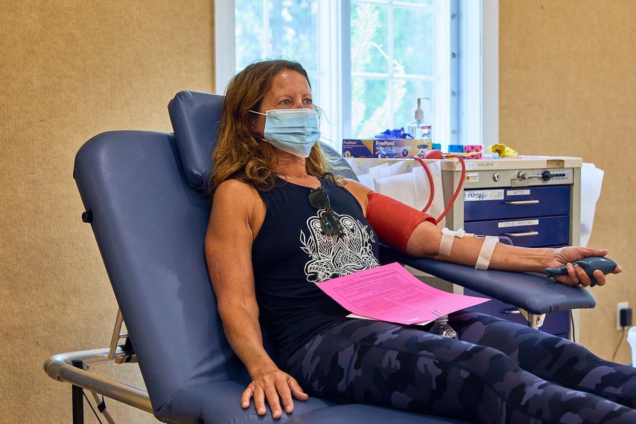 In this June 2021 file photo, Patti Anderson, from Eastham, donates blood for the first time to help Cape Cod Healthcare at the Church of Nazarene with the shortage of blood on Cape.