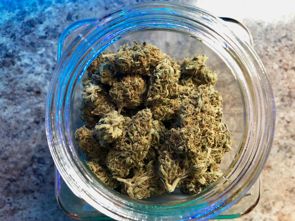 In this April 8, 2019, photo, a jar of medical marijuana sits on the counter at Western Oregon Dispensary in Sherwood, Ore. The dispensary is one of two medical-only marijuana dispensaries left in Oregon. An Associated Press analysis has found existing medical marijuana programs take a hit when states legalize cannabis for all adults. (AP Photo/Gillian Flaccus)