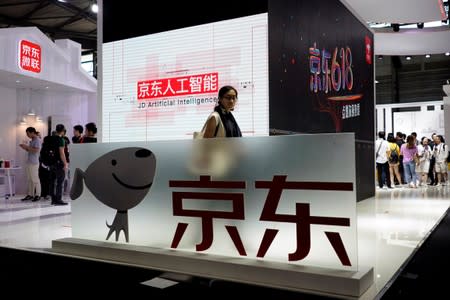 FILE PHOTO: A sign of China's e-commerce company JD.com is seen at CES (Consumer Electronics Show) Asia 2018 in Shanghai