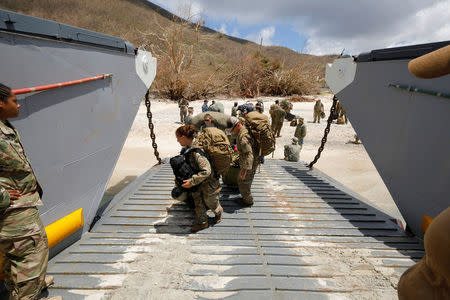 U.S. Army soldiers board a Navy landing craft during their evacuation in advance of Hurricane Maria, in Charlotte Amalie, St. Thomas, U.S. Virgin Islands September 17, 2017. REUTERS/Jonathan Drake