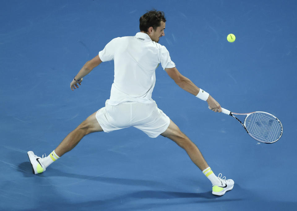 Russia's Daniil Medvedev hits a backhand return to Greece's Stefanos Tsitsipas during their semifinal match at the Australian Open tennis championship in Melbourne, Australia, Friday, Feb. 19, 2021.(AP Photo/Hamish Blair)