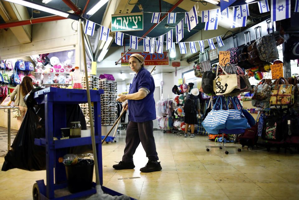 A cleaner near the shops inside the Central Bus Station on May 29. (Photo: Corinna Kern/Reuters)