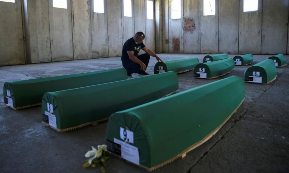 Coffins containing remains of newly identified victims before their burial