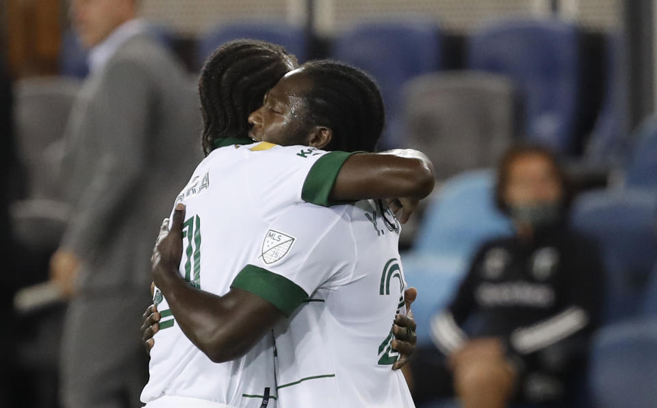 Portland Timbers midfielder Diego Chara, left, celebrates with forward Yimmi Chara, who scored a goal against the San Jose Earthquakes during the first half of an MLS soccer match Wednesday, Sept. 16, 2020, in San Jose, Calif. (AP Photo/Josie Lepe)