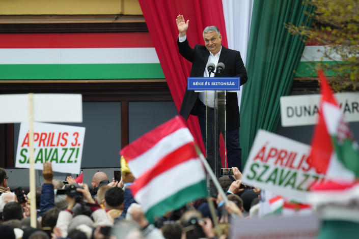 Hungarian Prime Minister Viktor Orbán waves to supporters from a stage on at an rally Friday ahead of Sunday's election.