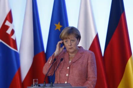 German Chancellor Angela Merkel listens during the news conference in Warsaw, Poland, August 26, 2016. REUTERS/Kacper Pempel