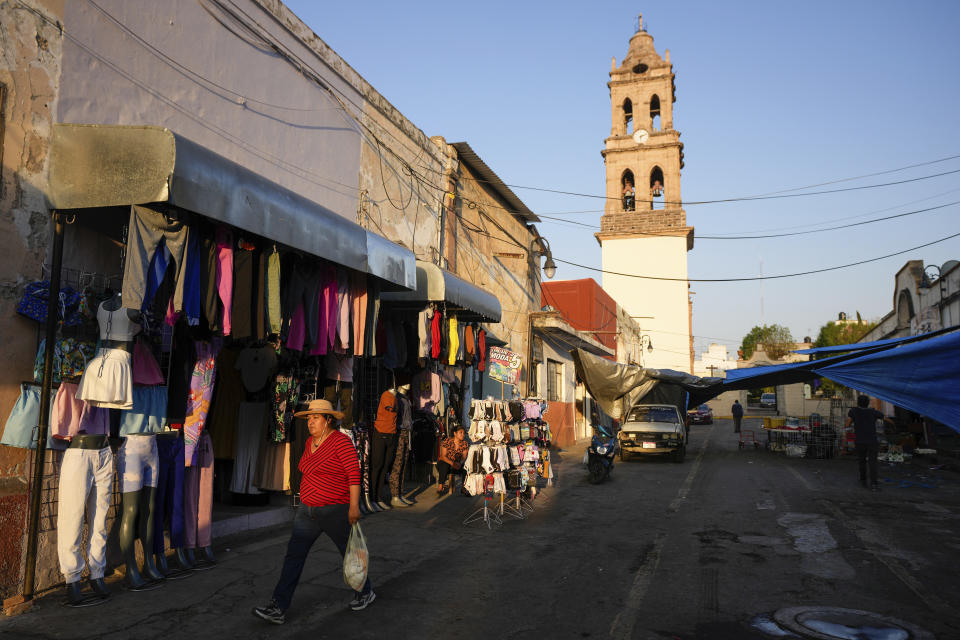 A woman walks in Maravatio, Michoacan state, Mexico,Tuesday, Feb. 27, 2024. Two mayoral hopefuls in this city were gunned down the previous day within hours of each other. (AP Photo/Fernando Llano)