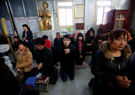 Believers take part in a weekend mass at an underground Catholic church in Tianjin November 10, 2013. REUTERS/Kim Kyung-Hoon/File Photo