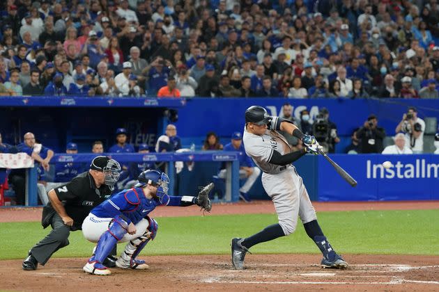 New York Yankees slugger Aaron Judge hits a home run Wednesday in the seventh inning to tie Roger Maris' American League record for most home runs in a single season, at 61, during the game against the Blue Jays in Toronto. (Photo: Thomas Skrlj/MLB Photos via Getty Images)