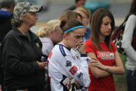 INDIANAPOLIS, IN - OCTOBER 17: Race fans mourn the loss of to two-time Indianapolis 500 winner Dan Wheldon as they view a memorial at the gate of the Indianapolis Motor Speedway on October 17, 2011 in Indianapolis, Indiana. Wheldon, winner of the 2005 and 2011 Indy 500 races, was killed in a crash yesterday at the Izod IndyCar series season finale at Las Vegas Motor Speedway. (Photo by Scott Olson/Getty Images)