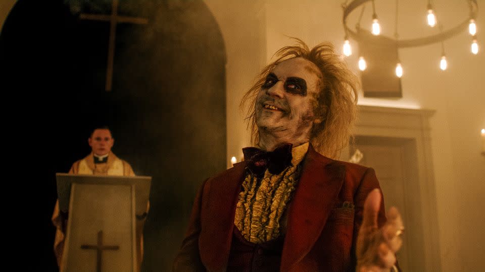 Beetlejuice's renowned burgundy wedding tux makes an appearance in the film's remake. - Warner Brothers Discovery