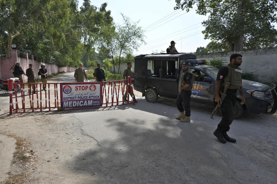 Police officers stand guard at a checkpoint on a road leading to the District Jail, in Attock, Pakistan, Wednesday, Aug. 30, 2023. A court asked the official in charge of the Attock prison to keep former Prime Minister Khan there until at least Wednesday, when Khan is expected to face a hearing on charges of "exposing an official secret document" in an incident last year when he waved a confidential diplomatic letter at a rally. The Islamabad High Court on Tuesday suspended the corruption conviction and three-year prison term of him, his lawyers and court officials said. (AP Photo/Anjum Naveed)