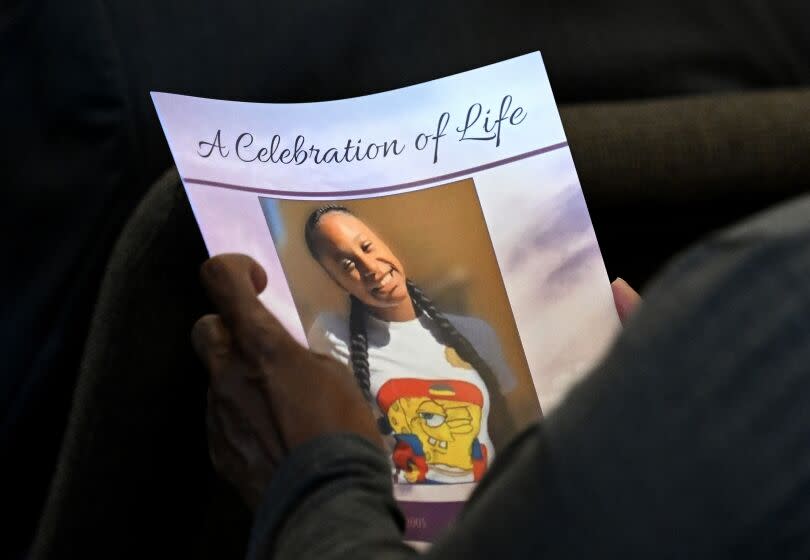 A smiling Tioni Theus is seen on a program during her funeral in Los Angeles.