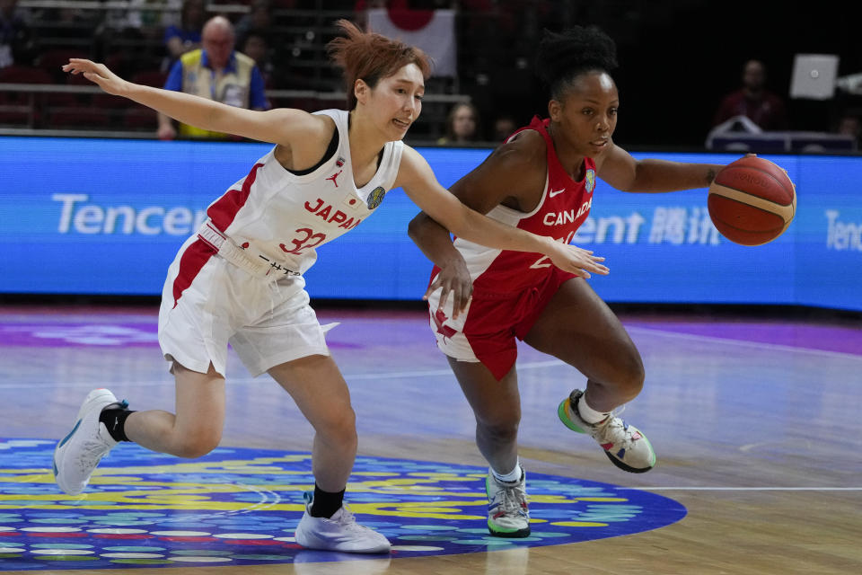 Canada's Nirra Fields, right, runs past Japan's Saori Miyazaki during their game at the women's Basketball World Cup in Sydney, Australia, Sunday, Sept. 25, 2022. (AP Photo/Mark Baker)