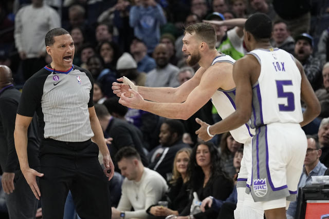 Sacramento Kings forward Domantas Sabonis, second from right, reacts toward referee Nate Green, left, after being called for a foul during the second half of an NBA basketball game against the Minnesota Timberwolves, Monday, Jan. 30, 2023, in Minneapolis. (AP Photo/Abbie Parr)