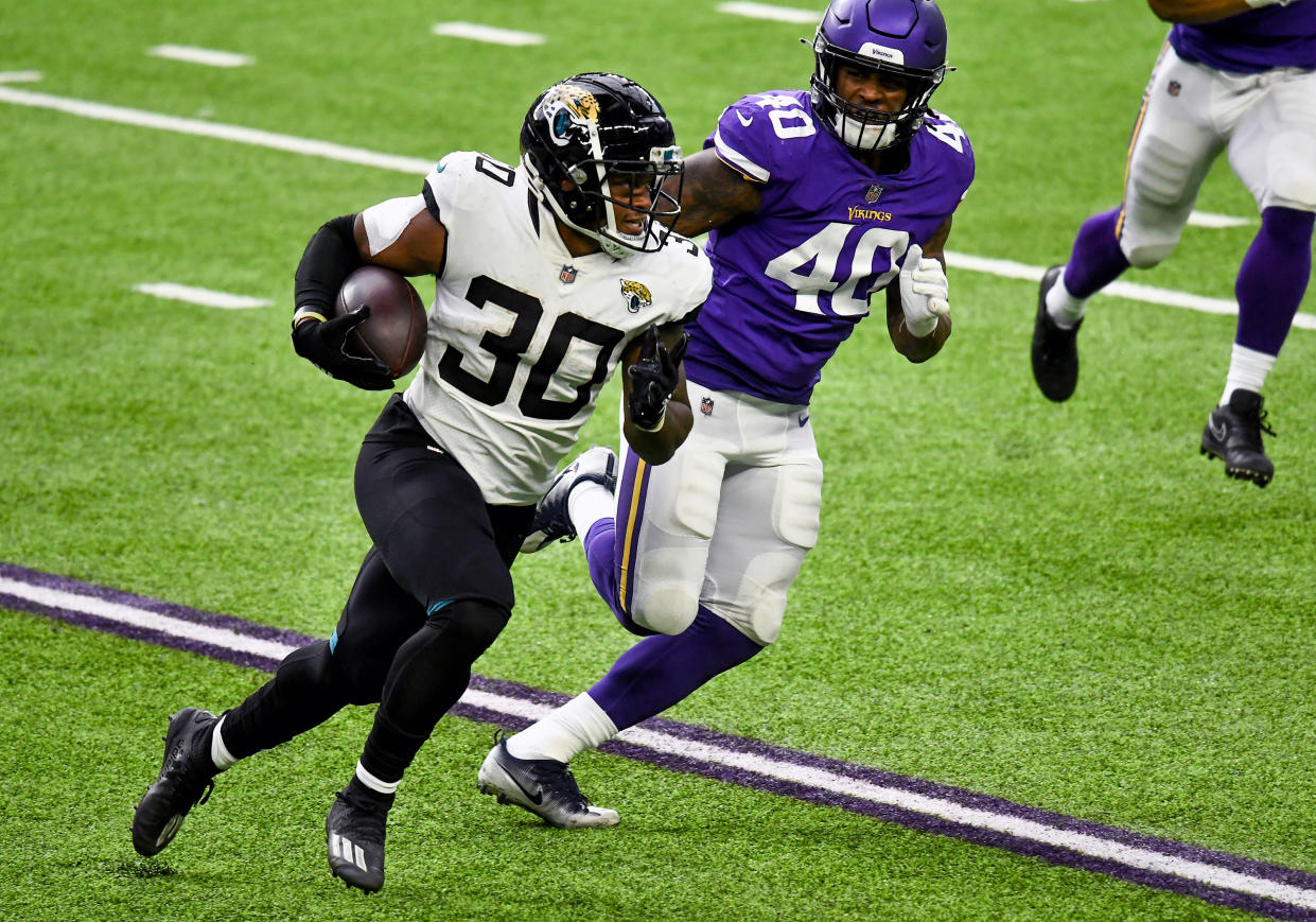 MINNEAPOLIS, MN - DECEMBER 06:  Jacksonville Jaguars Running Back James Robinson (30) runs with the ball as Minnesota Vikings Linebacker Todd Davis (40) gives chase during the 2nd quarter of a National Football League game between the Minnesota Vikings and Jacksonville Jaguars on December 6, 2020, at US Bank Stadium, Minneapolis, MN.(Photo by Nick Wosika/Icon Sportswire via Getty Images)
