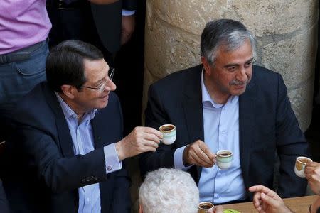 Turkish Cypriot leader Mustafa Akinci (R) and Greek Cypriot leader, Cypriot President Nicos Anastasiades, drink coffee in old Nicosia May 23, 2015. REUTERS/Yiannis Kourtoglou