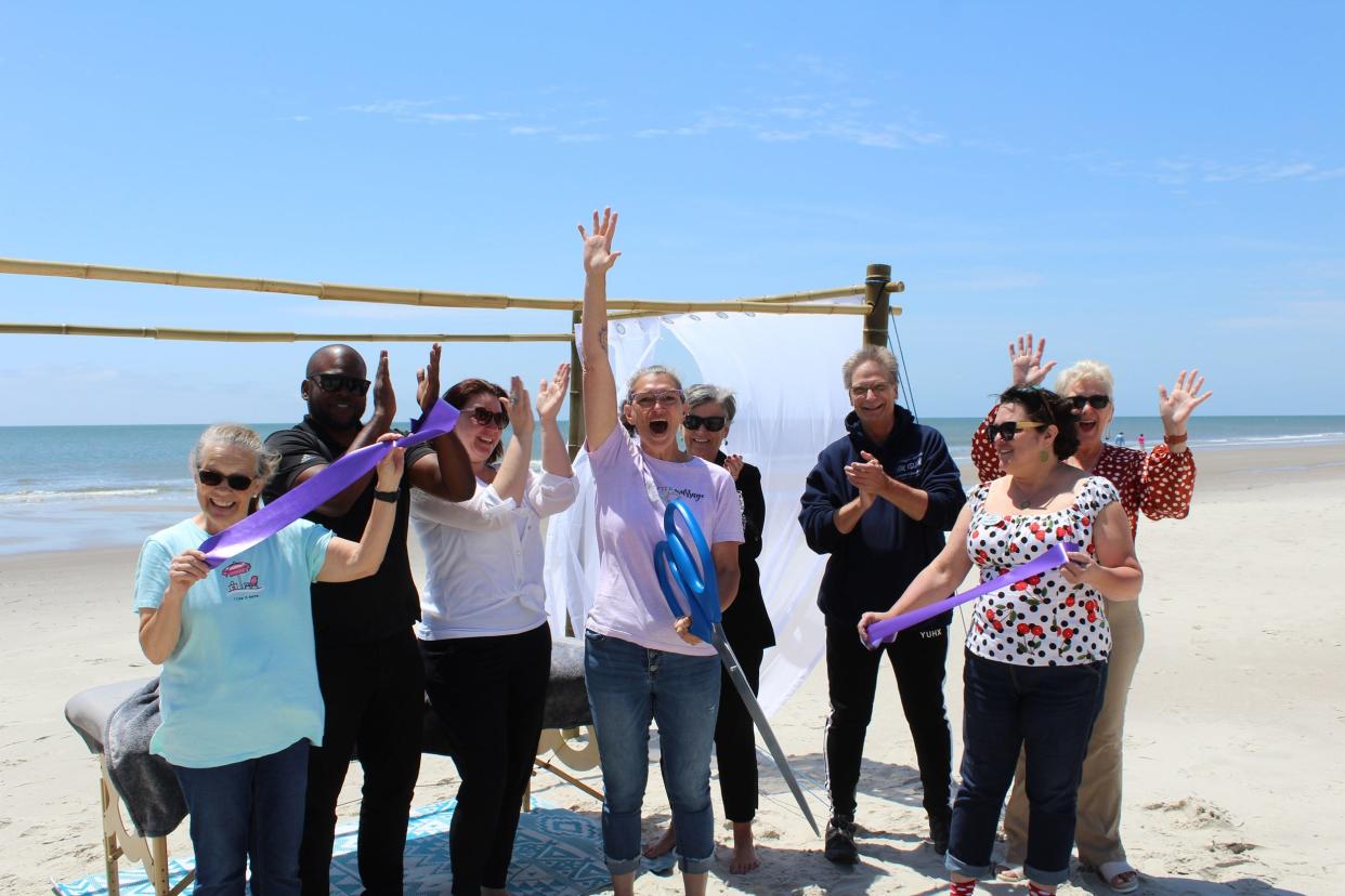 A ribbon cutting was recently held for Hand Crafted Massage's mobile massage beach cabana.