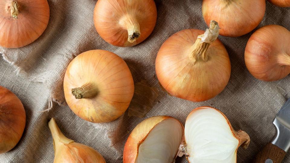 raw organic onions on linen sackcloth