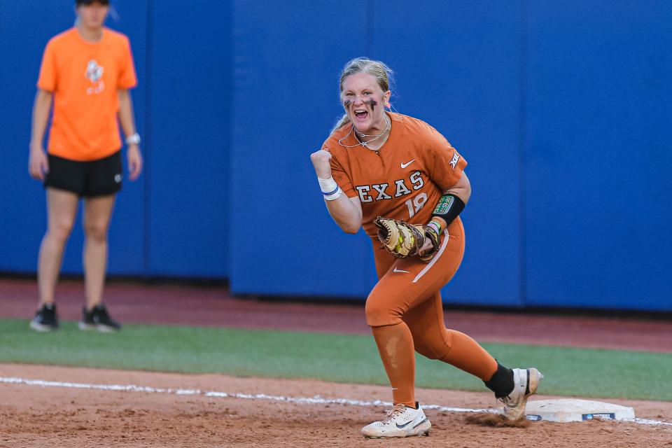 Texas' JJ Smith celebrates after tagging a runner out against Oklahoma State.