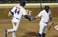 Chicago Cubs' Anthony Rizzo (44) is greeted by Kyle Schwarber (12) after scoring against the Minnesota Twins during the first inning of a baseball game, Friday, Sept. 18, 2020, in Chicago. (AP Photo/David Banks)