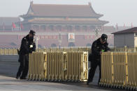 Chinese police officers push away barriers before delegates arrive for a meeting on the eve of the opening session of the National People's Congress held at the Great Hall of the People in Beijing, China, Monday, March 4, 2019. A year since removing any legal barrier to remaining China's leader for life, Xi Jinping appears firmly in charge, despite a slowing economy, an ongoing trade war with the U.S. and rumbles of discontent over his concentration of power. (AP Photo/Ng Han Guan)