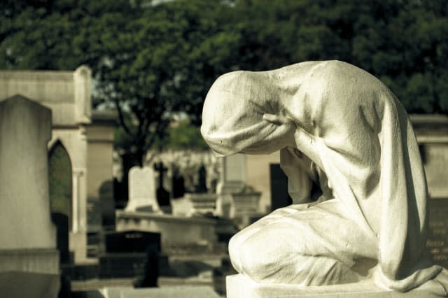 Statue of weeping woman on a grave