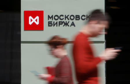 People walk past the Moscow Exchange in Moscow, Russia, May 26, 2017. REUTERS/Segrei Karpukhin