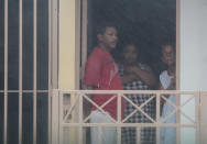 <p>People look out from a house as Hurricane Irma howls past Puerto Rico after thrashing several smaller Caribbean islands, in Fajardo, Puerto Rico, Sept. 6, 2017. (Photo: Alvin Baez/Reuters) </p>