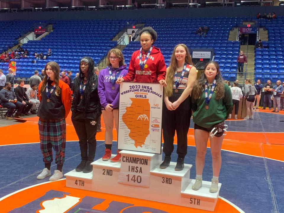 El Paso-Gridley's Savannah Hamilton, third from the left, poses on the podium following her 140-pound title bout at the inaugural IHSA girls wrestling state meeting. The freshman lost a 6-2 decision to Antonia Phillips of Alton.