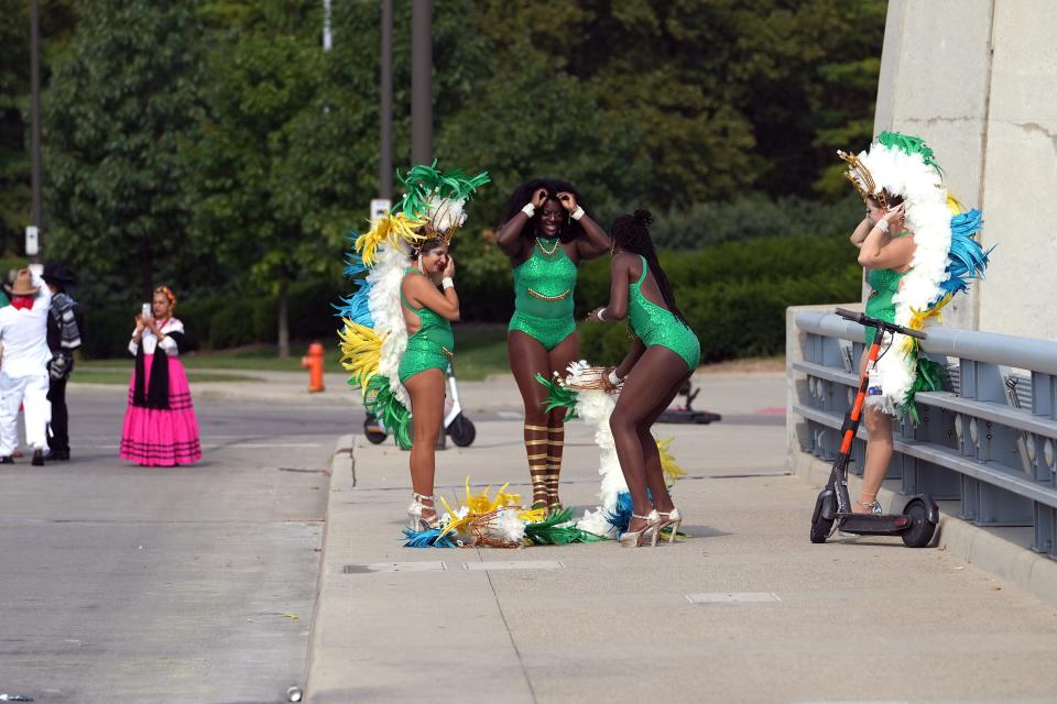 Dancers from the Pittsburgh Samba Group prepare their headdresses to walk Saturday in the first Columbus Latine/Hispanic Heritage Month parade.