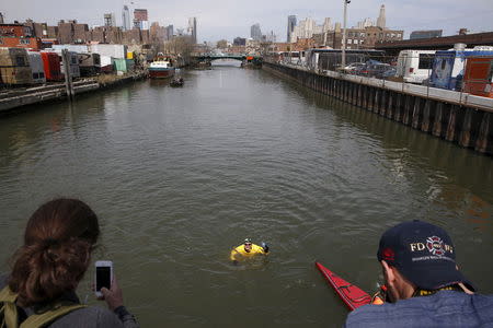 Christopher Swain, a clean-water activist, swims in the Gowanus Canal in the Brooklyn borough of New York April 22, 2015. REUTERS/Shannon Stapleton