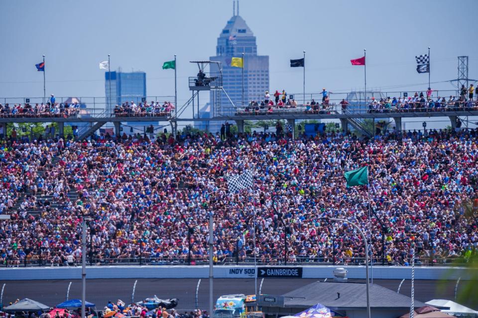 With a view of Indianapolis in the background, fans watch from turn two with Sunday, May 29, 2022, during the 106th running of the Indianapolis 500 at Indianapolis Motor Speedway.